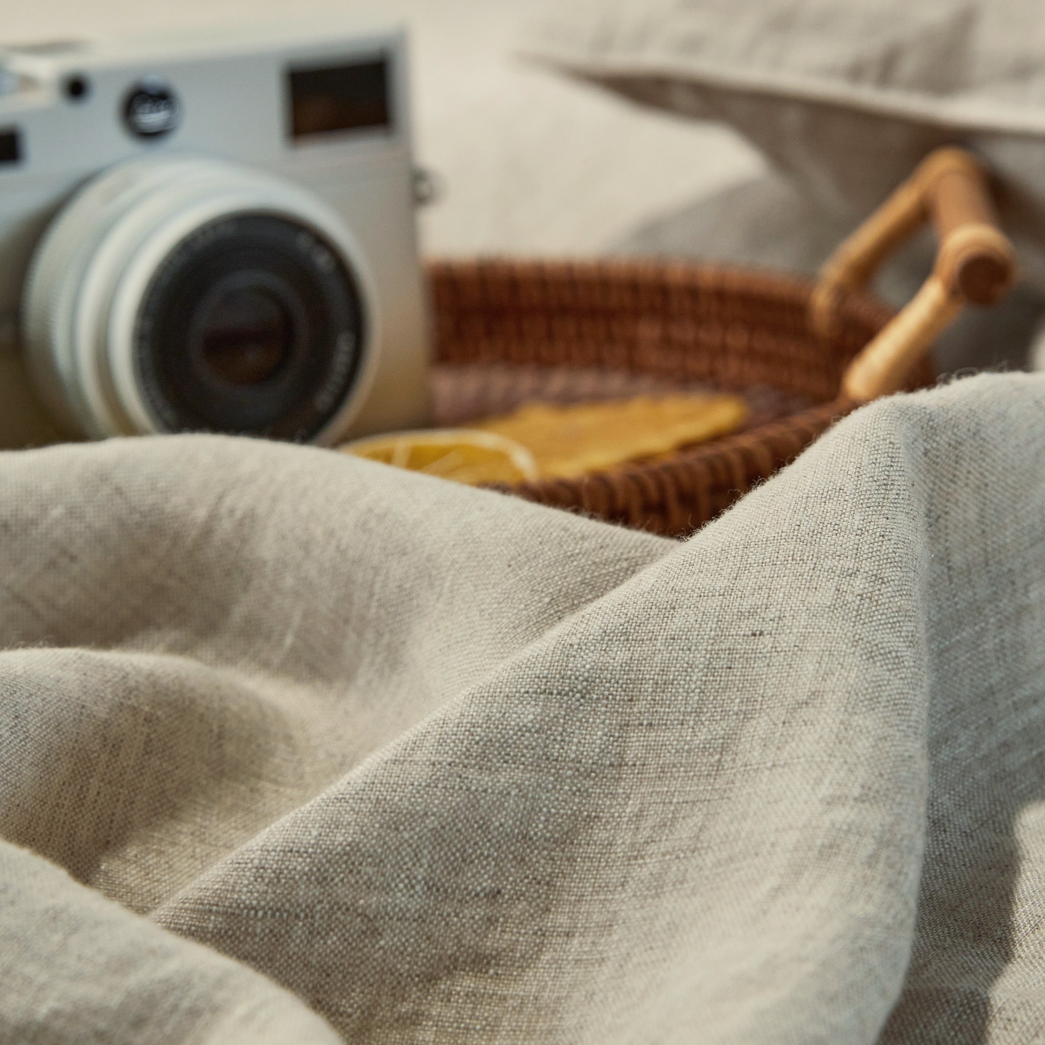 Detailed natural-colored linen fabric showing its actual woven texture and folds